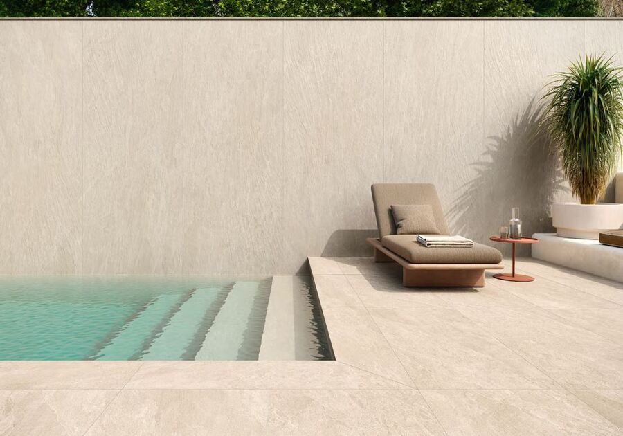 carrelage beige ton pierre imitation ardoise au bord du piscine avec un mur carrelé avec le même carreau que le sol